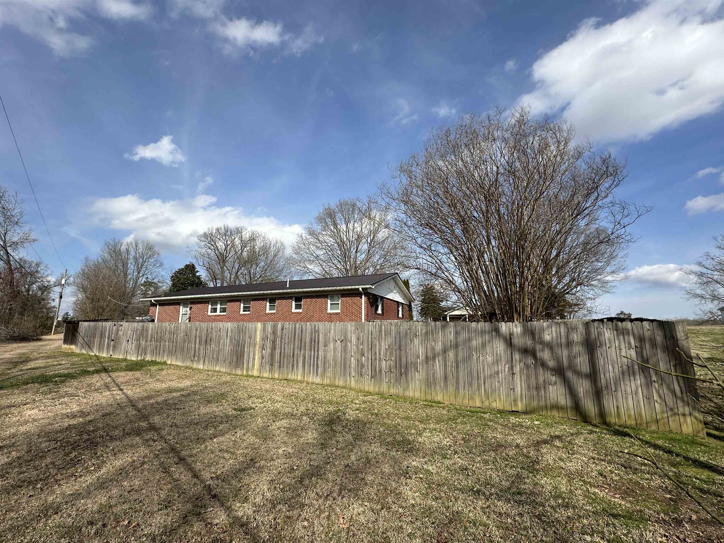 92 Puron Road Adamsville, TN 38310 - Photo 5 of 23 a view of outdoor space with swimming pool and trees