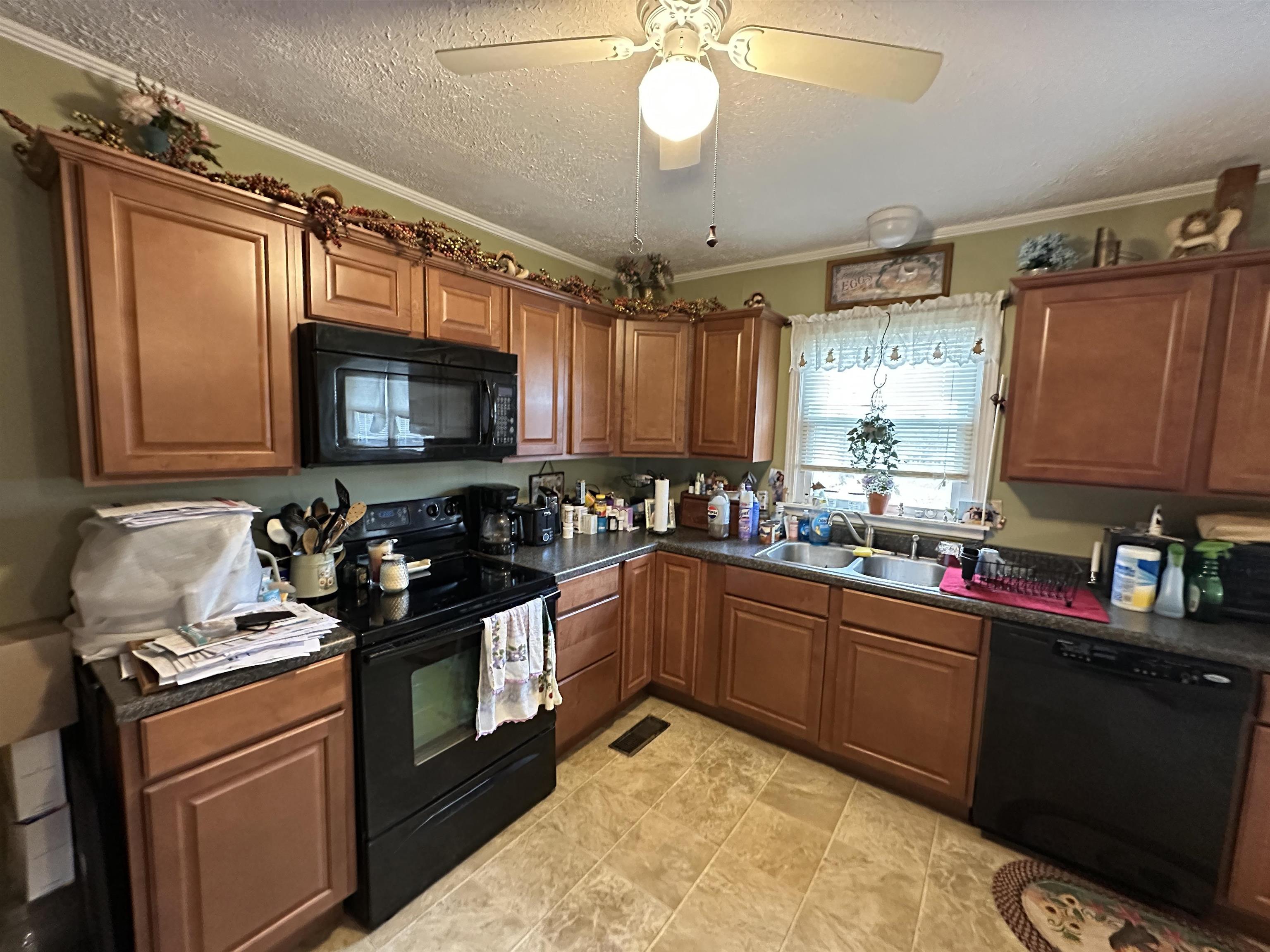 92 Puron Road Adamsville, TN 38310 - Photo 9 of 23 a kitchen with a sink stove and microwave