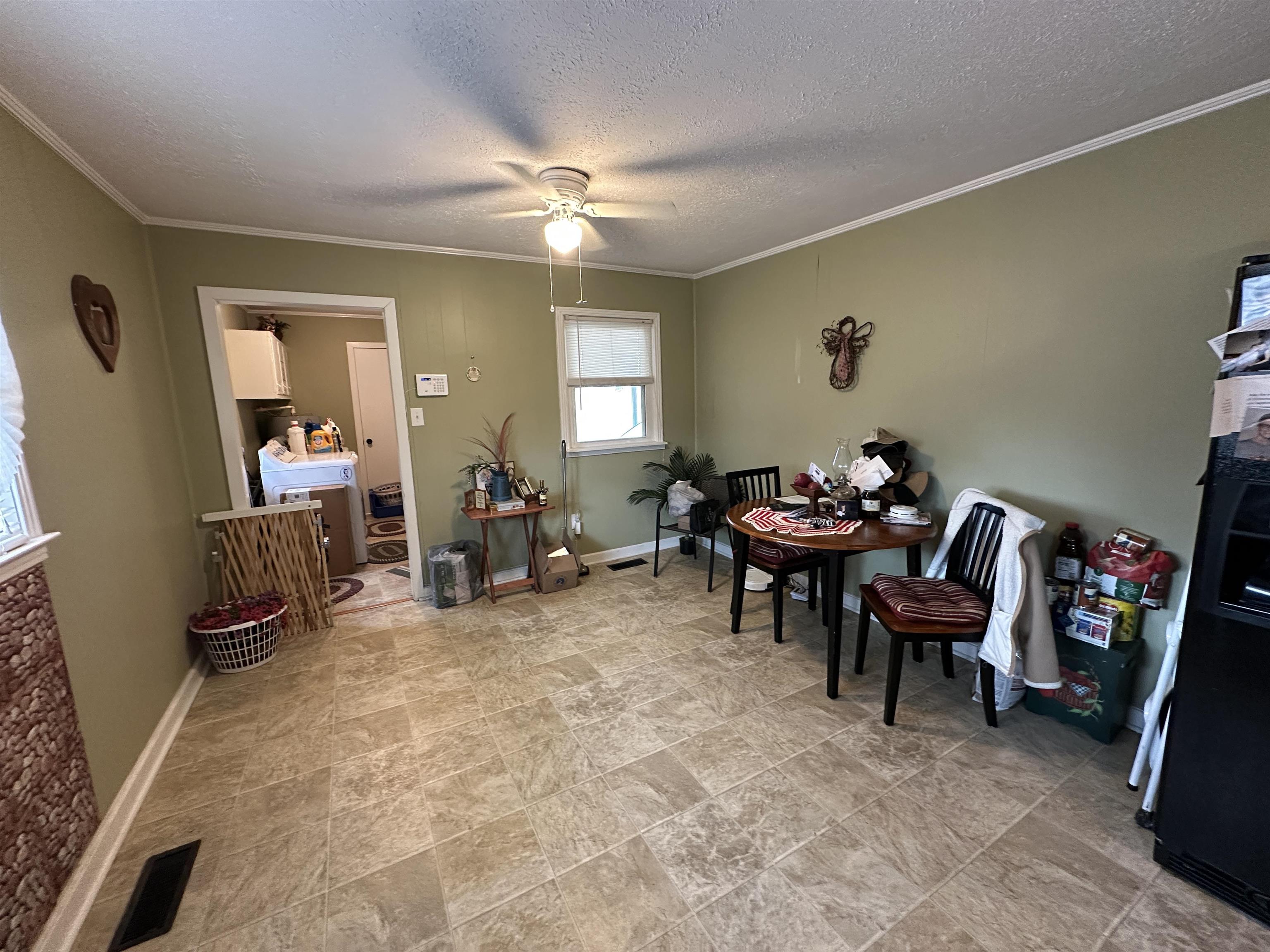 92 Puron Road Adamsville, TN 38310 - Photo 10 of 23 a living room with furniture and a dining table with wooden floor
