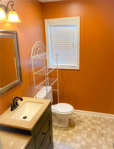 a bathroom with a sink a toilet and mirror