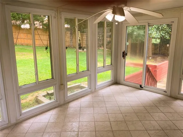 a view of an empty room with windows