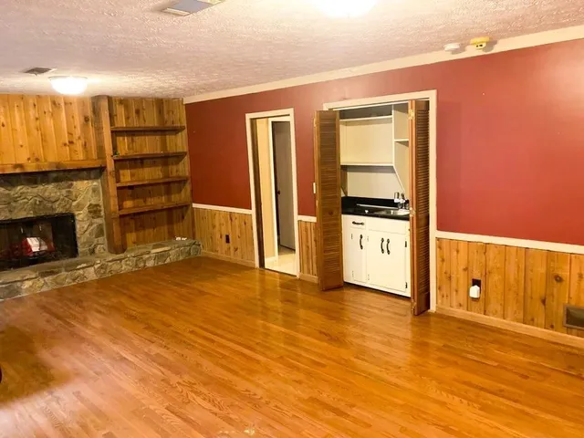 a view of a kitchen with a sink and a fireplace