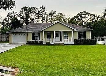 96 Redwood Road Ocala, FL 34472 - Photo 1 of 10 a front view of a house with a yard