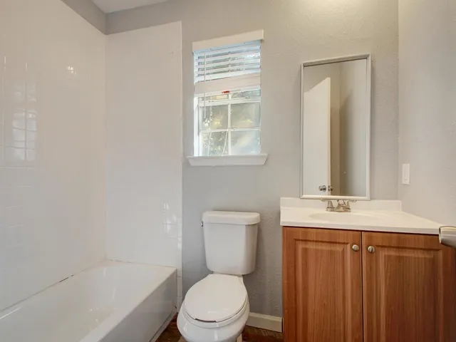 a blue sign board with buildings in the background