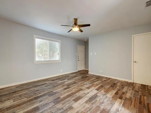 a kitchen with granite countertop white cabinets and window