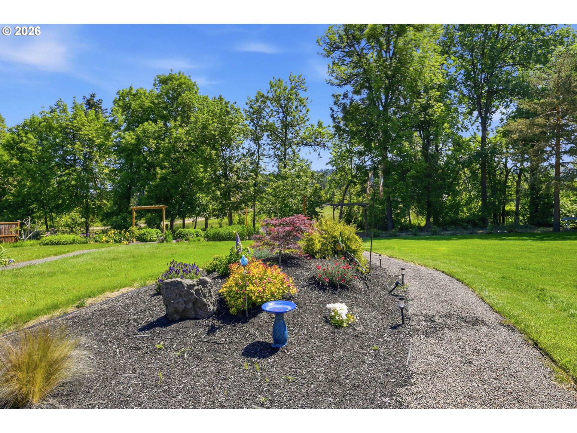 29778 Gimpl Hill Road Eugene, OR 97405 - Photo 37 of 43 a backyard of a house with a garden and outdoor seating