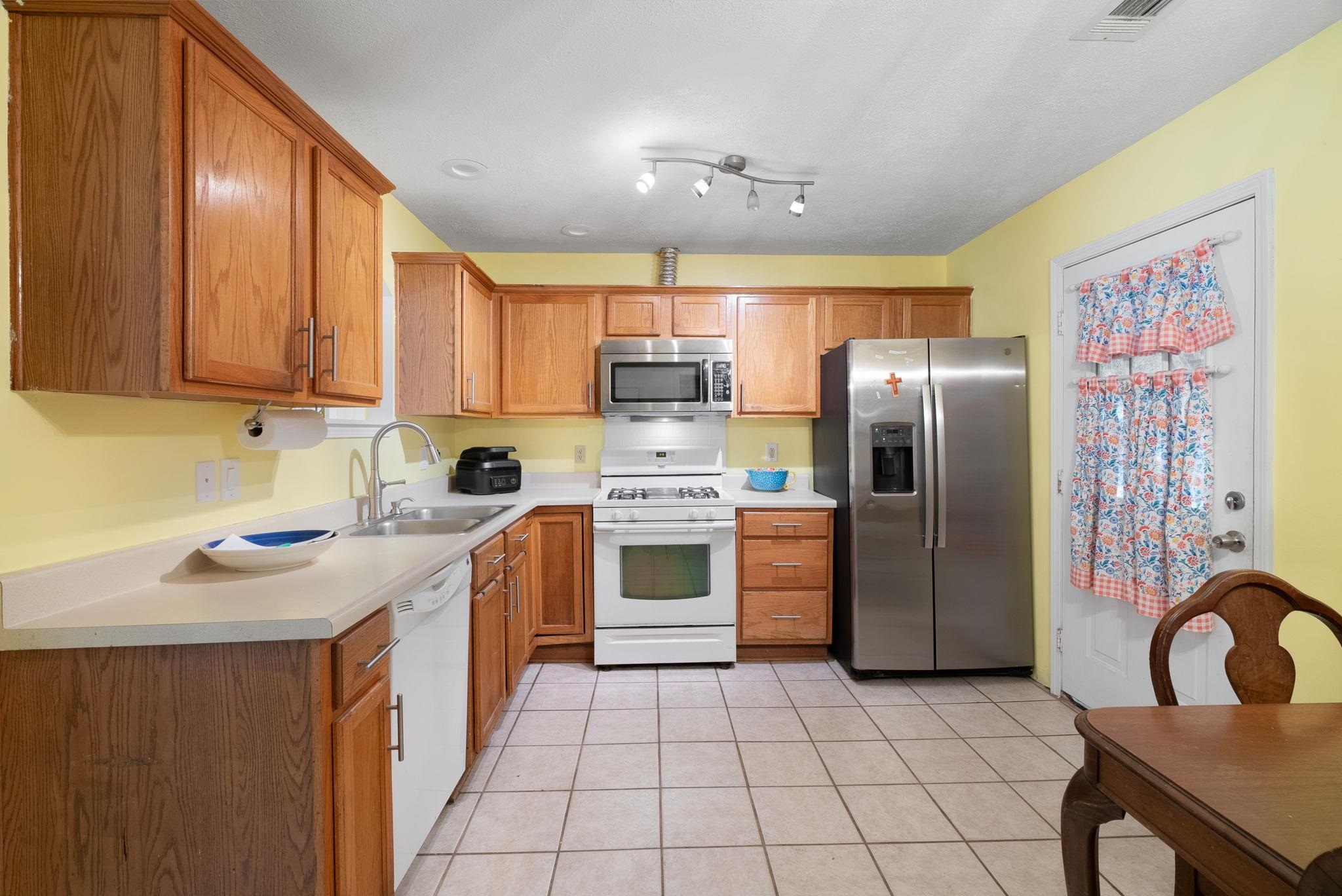 310 Liberty Road Moscow, TN 38057 - Photo 11 of 32 a kitchen with stainless steel appliances granite countertop a refrigerator and a stove top oven