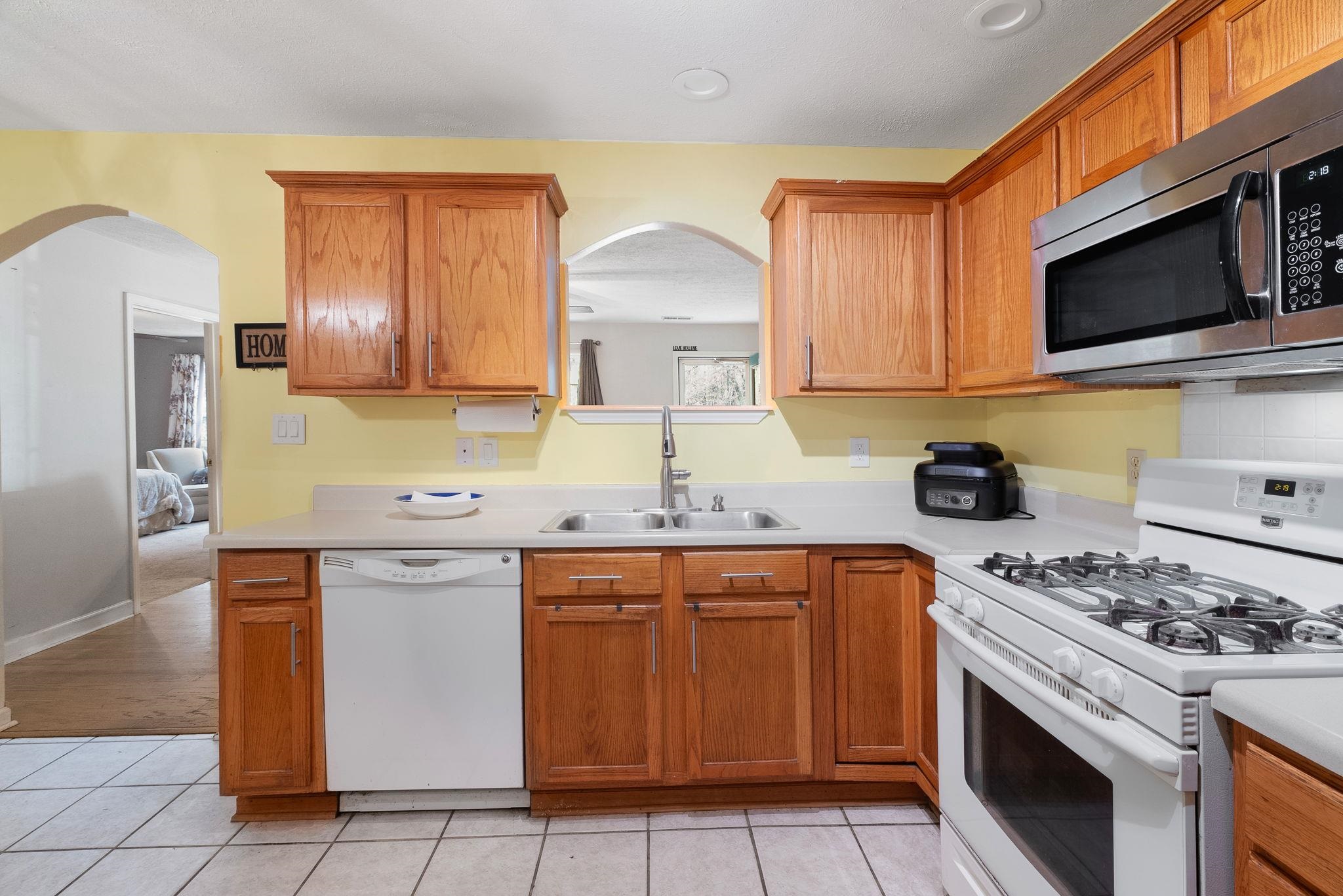 310 Liberty Road Moscow, TN 38057 - Photo 12 of 32 a kitchen with stainless steel appliances granite countertop a stove a sink and a microwave