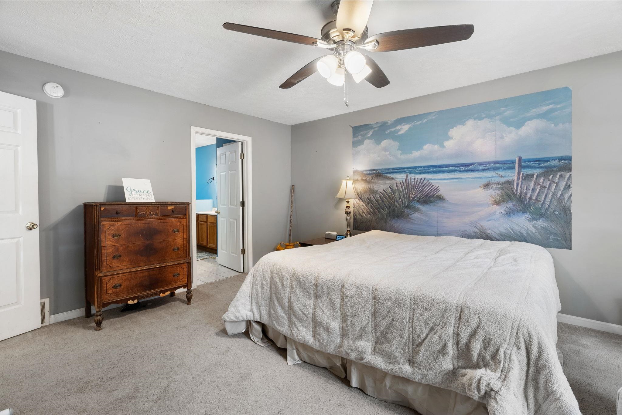 310 Liberty Road Moscow, TN 38057 - Photo 15 of 32 a bedroom with a bed a dresser and a chandelier