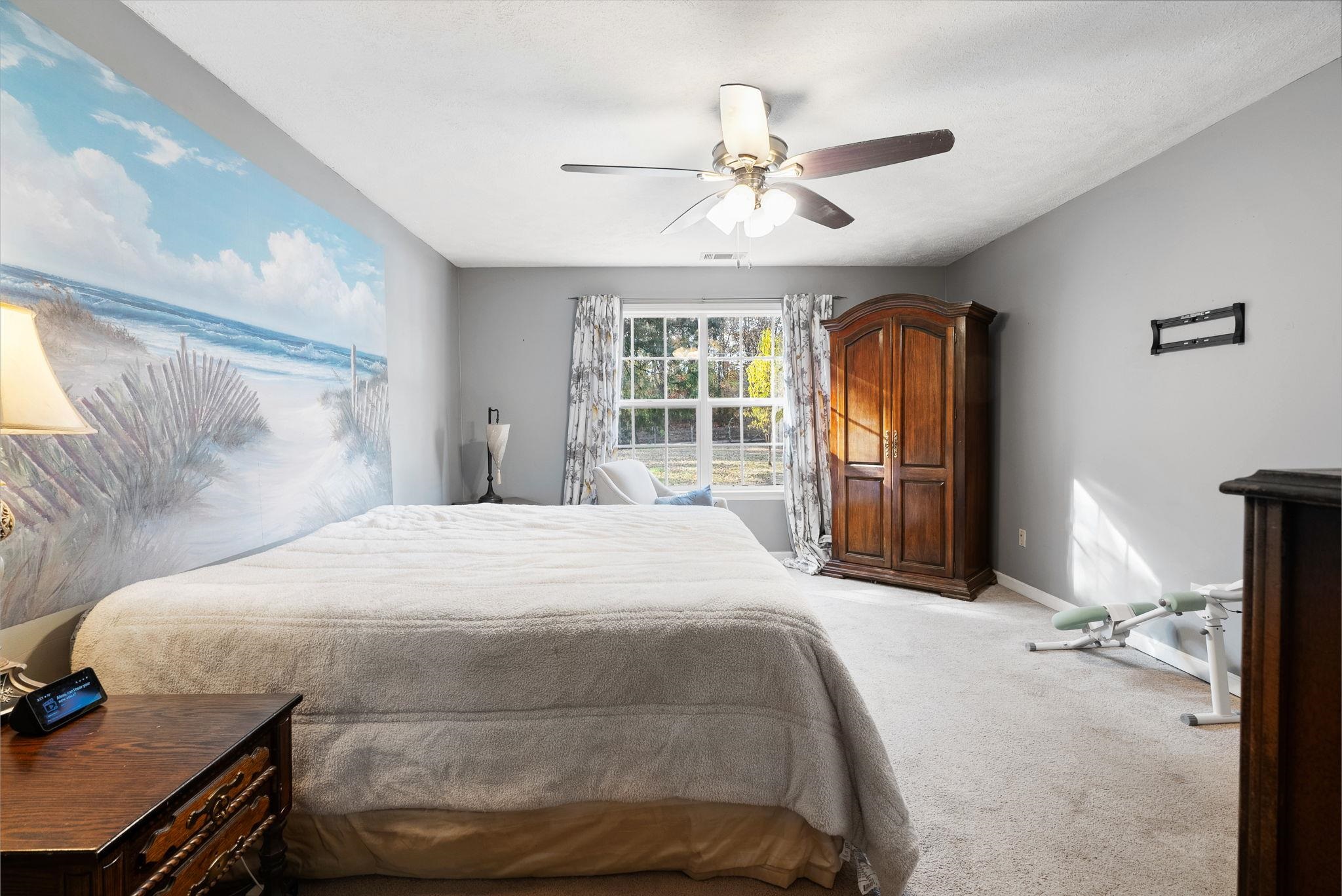 310 Liberty Road Moscow, TN 38057 - Photo 16 of 32 a bedroom with a large bed and a chandelier