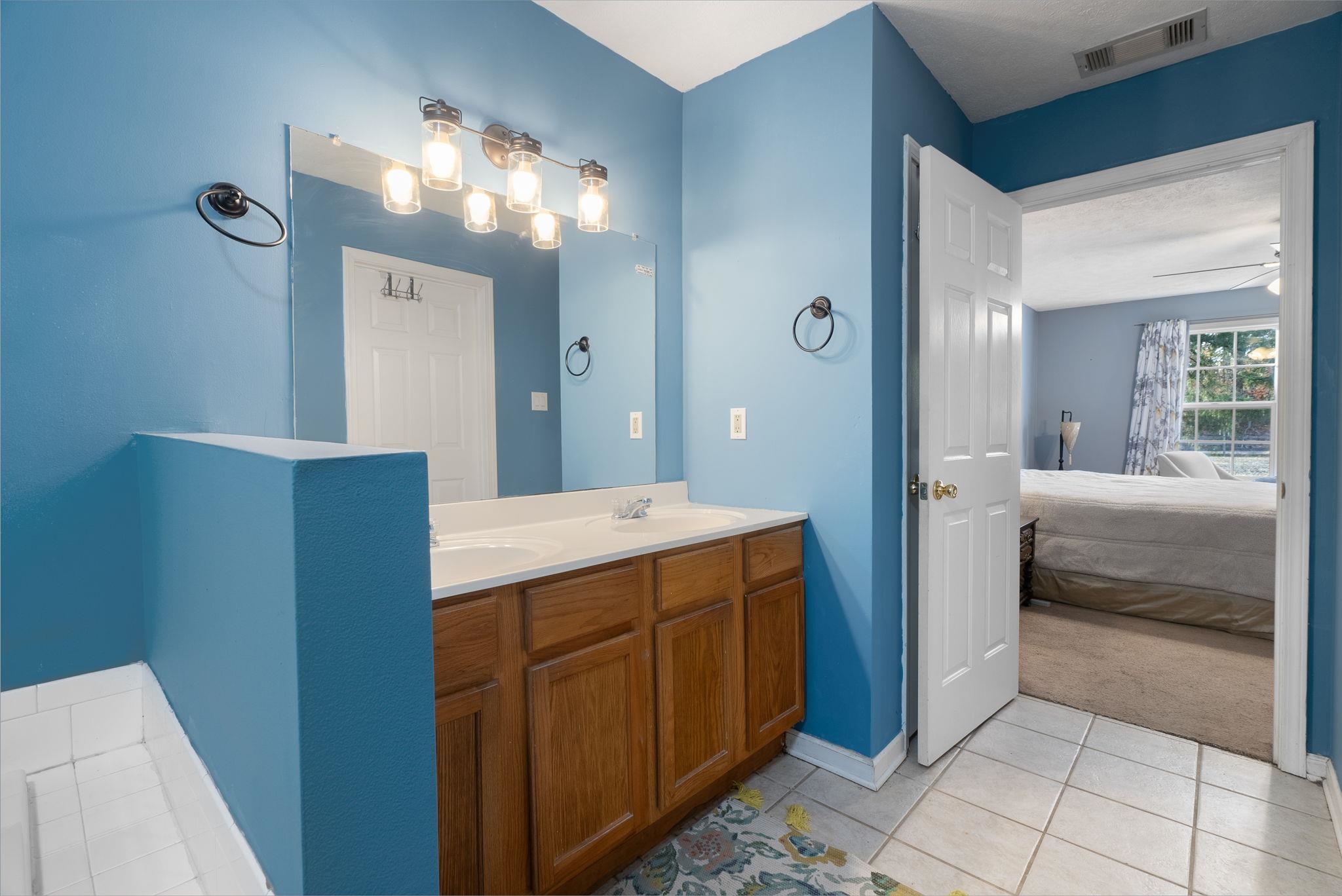 310 Liberty Road Moscow, TN 38057 - Photo 20 of 32 a bathroom with a sink a mirror and a shower