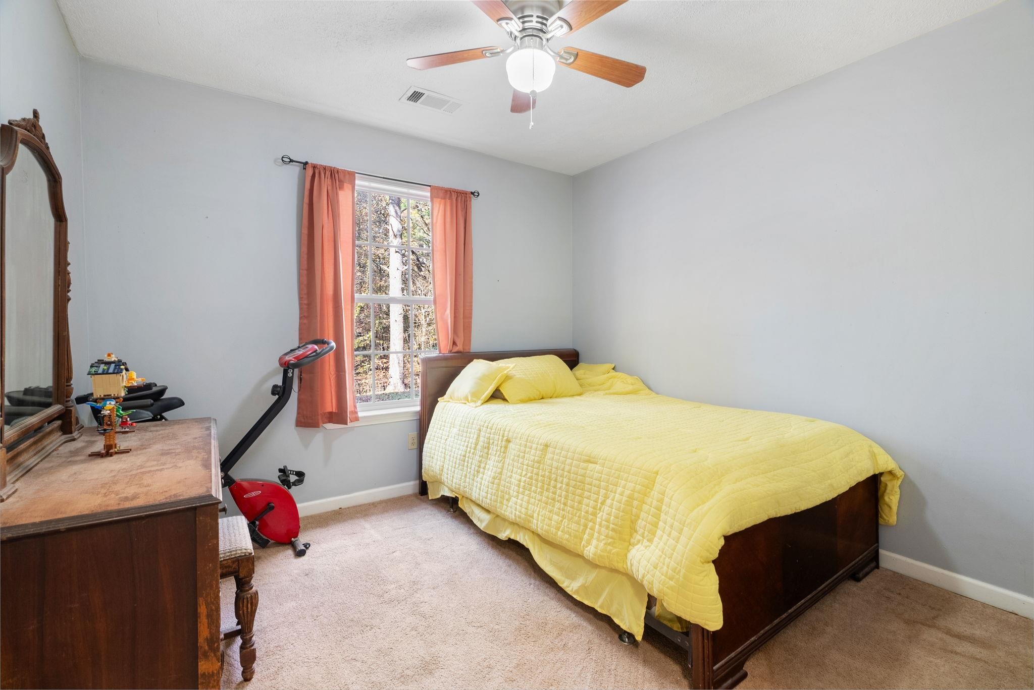 310 Liberty Road Moscow, TN 38057 - Photo 22 of 32 a bed sitting in a room next to a window