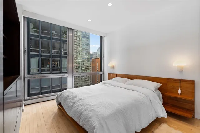 a spacious bedroom with a bed and a dresser