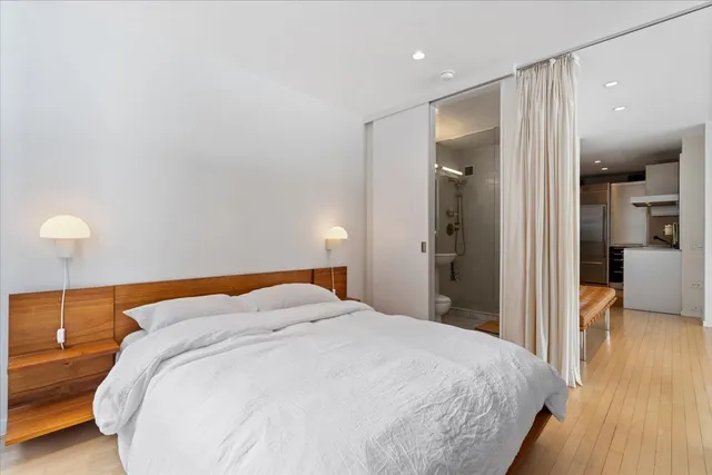 a bedroom with a bed and a view of bathroom