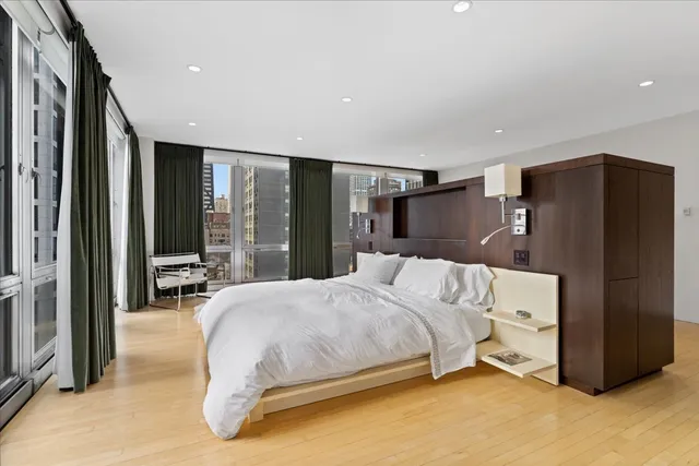 a bedroom with a large bed and a large window