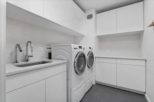 a utility room with sink dryer and washer