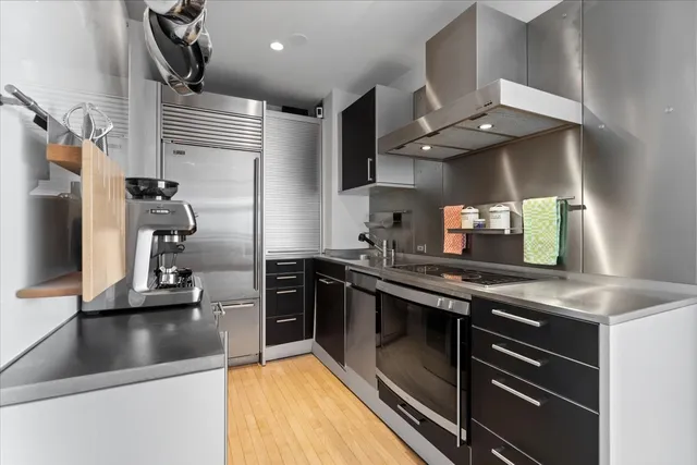 a kitchen with stainless steel appliances granite countertop a sink and a stove