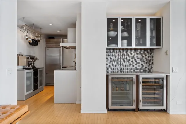 a kitchen with cabinets and wooden floor
