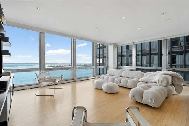 a living room with furniture and floor to ceiling window