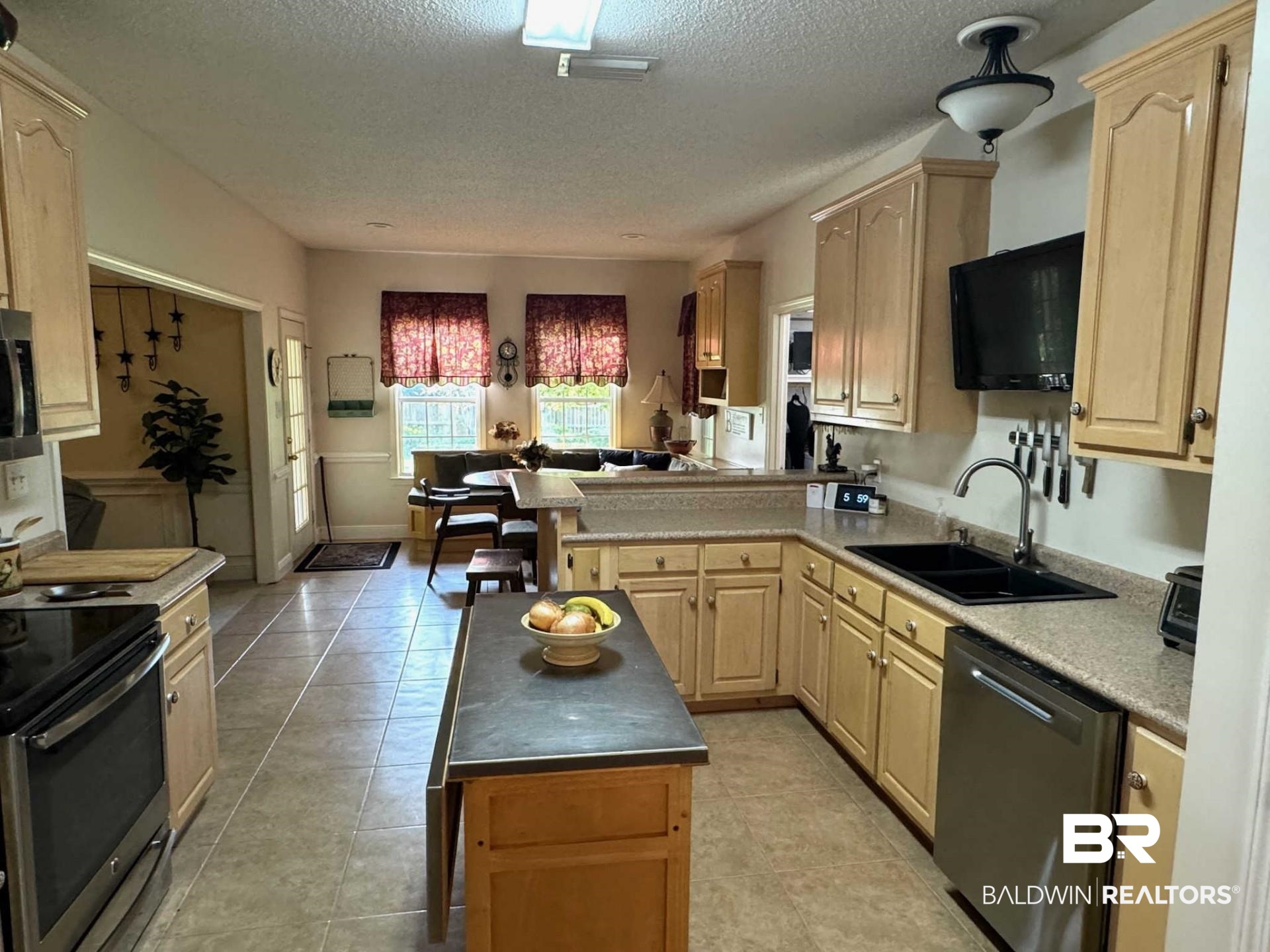 31163 Woodland Way Daphne, AL 36527 - Photo 20 of 44 Kitchen featuring sink, stainless steel appliances, light tile patterned floors, and light brown cabinets
