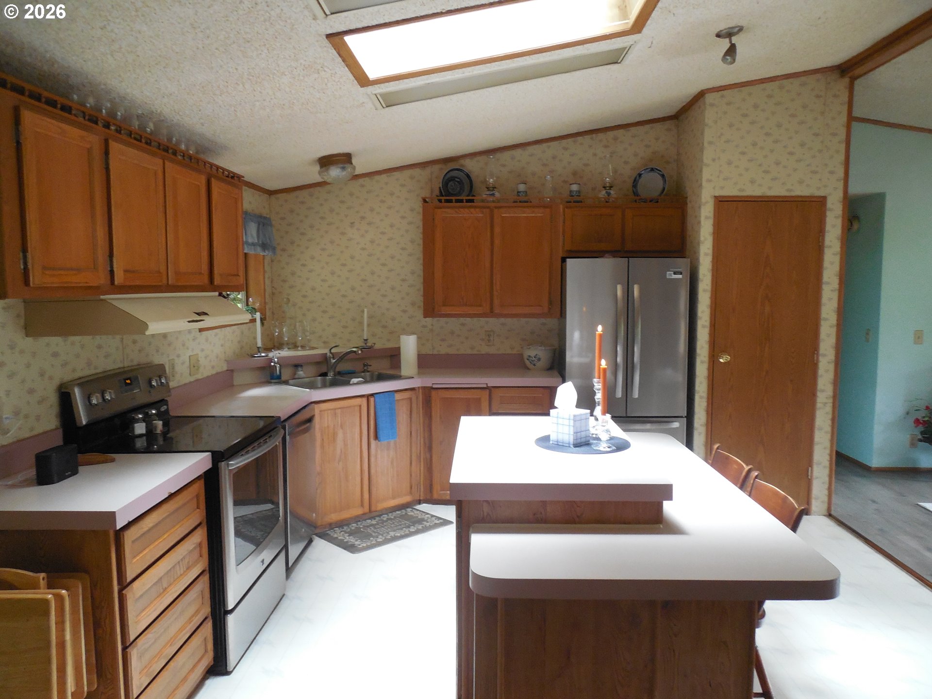 41180 Southeast Kubitz Road Sandy, OR 97055 - Photo 35 of 38 a kitchen with a sink refrigerator and cabinets