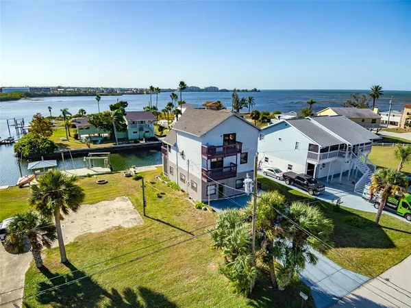 an aerial view of a house with swimming pool and outdoor seating