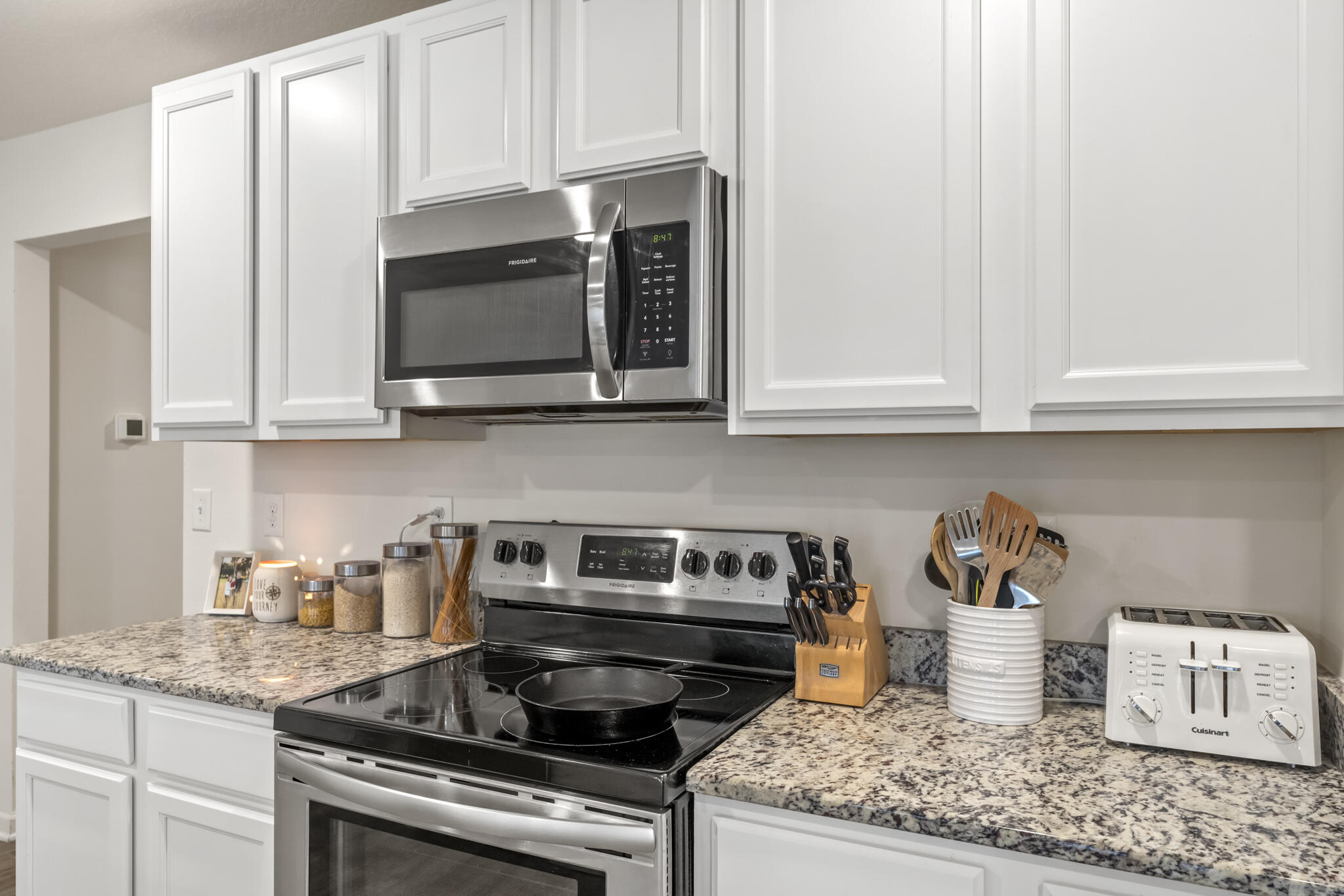 916 Merganser Way Crestview, FL 32539 - Photo 11 of 27 a kitchen with stainless steel appliances granite countertop a stove a microwave and cabinets