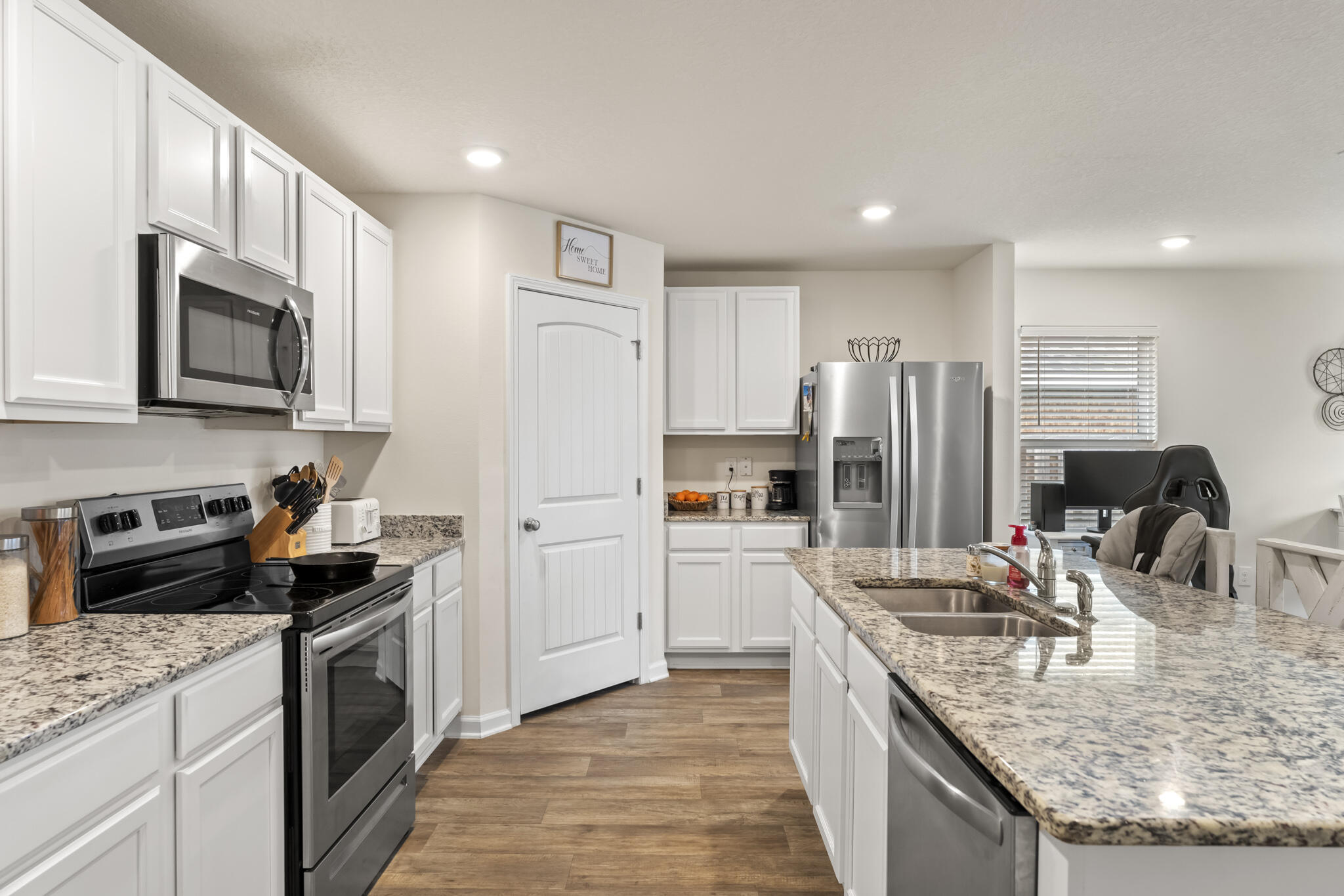 916 Merganser Way Crestview, FL 32539 - Photo 12 of 27 a kitchen with stainless steel appliances granite countertop a sink stove and refrigerator