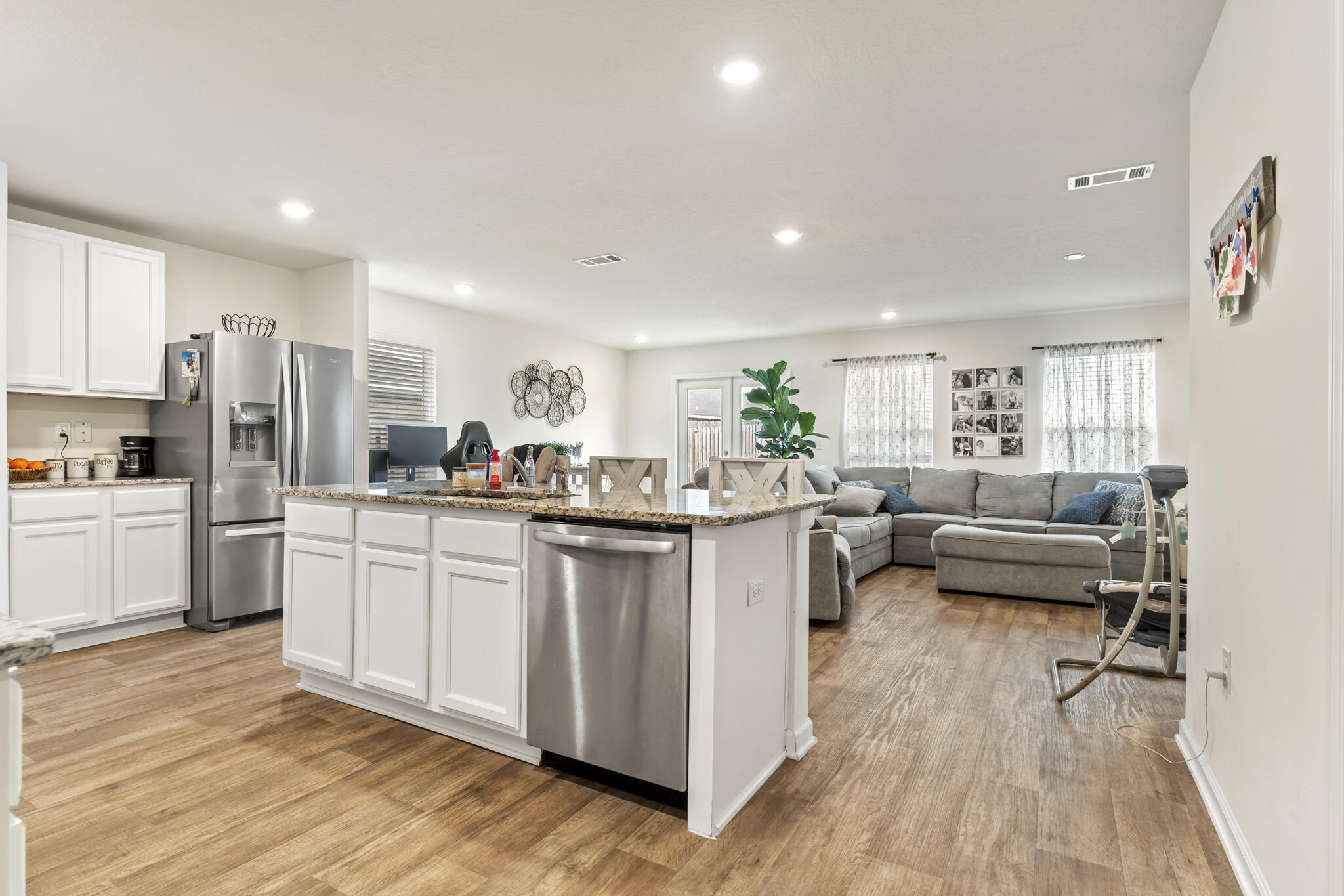 916 Merganser Way Crestview, FL 32539 - Photo 6 of 27 a kitchen with white cabinets and stainless steel appliances