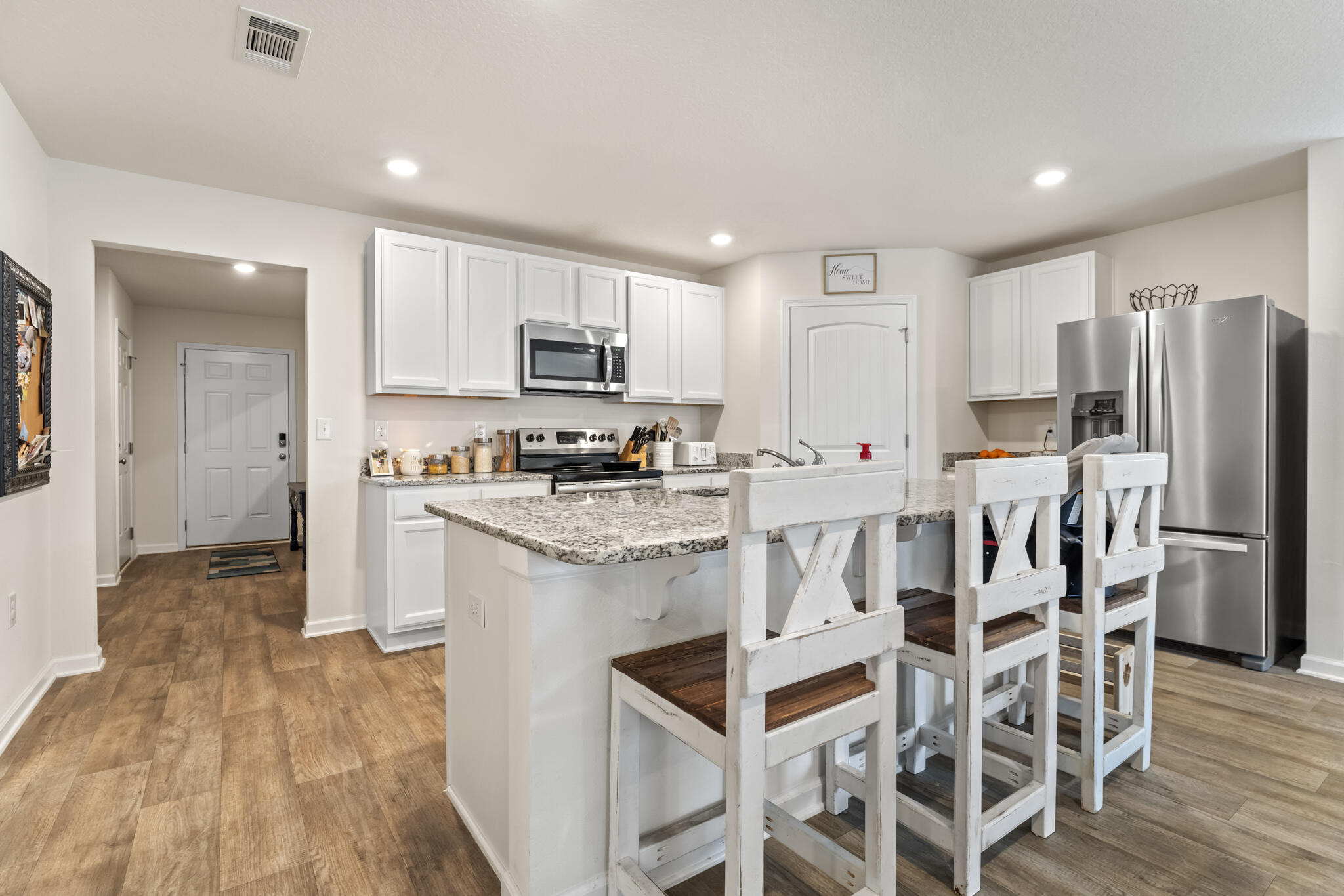 916 Merganser Way Crestview, FL 32539 - Photo 10 of 27 a kitchen with stainless steel appliances kitchen island granite countertop a refrigerator and a stove top oven