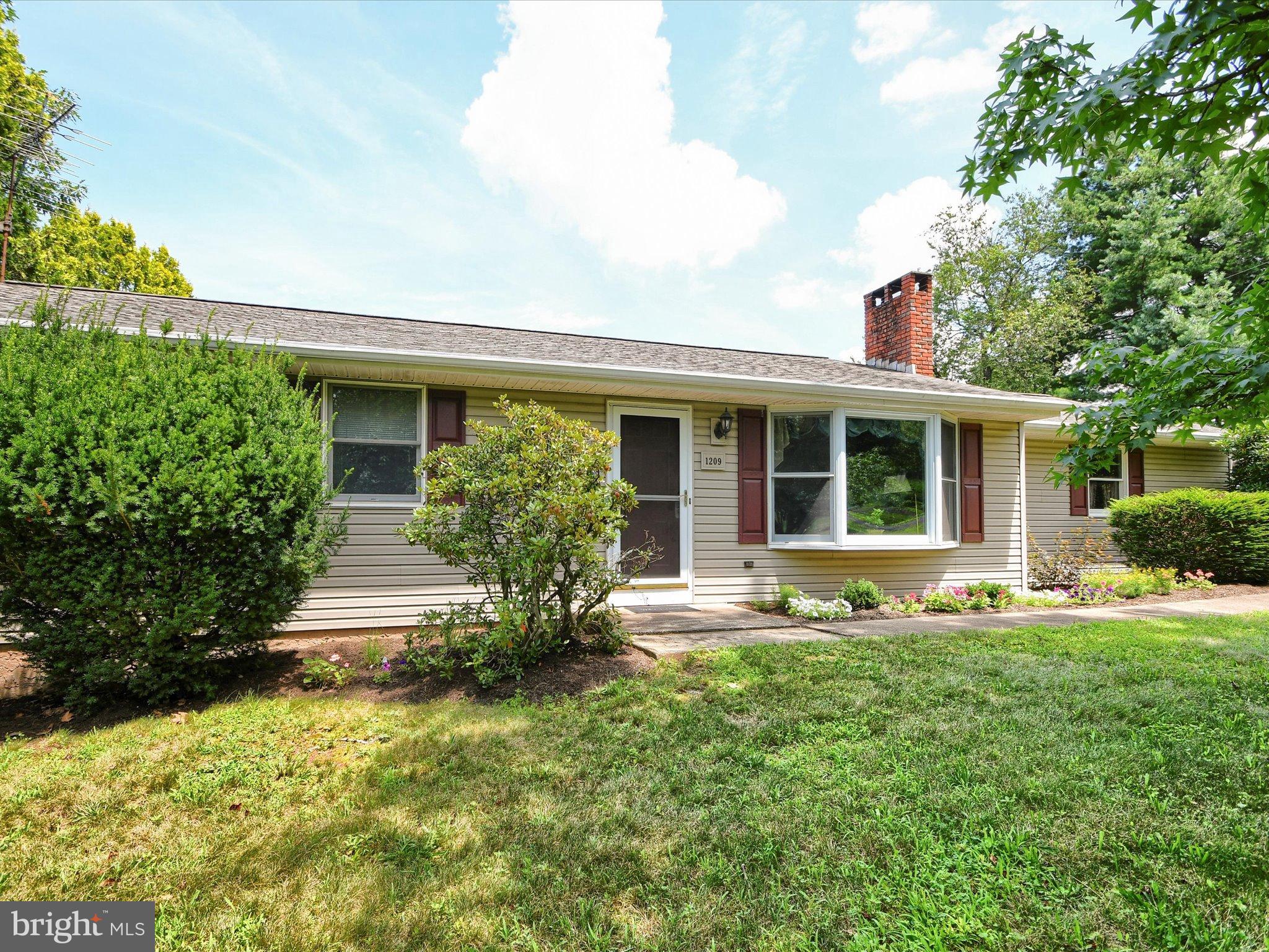 a front view of house with a garden and patio
