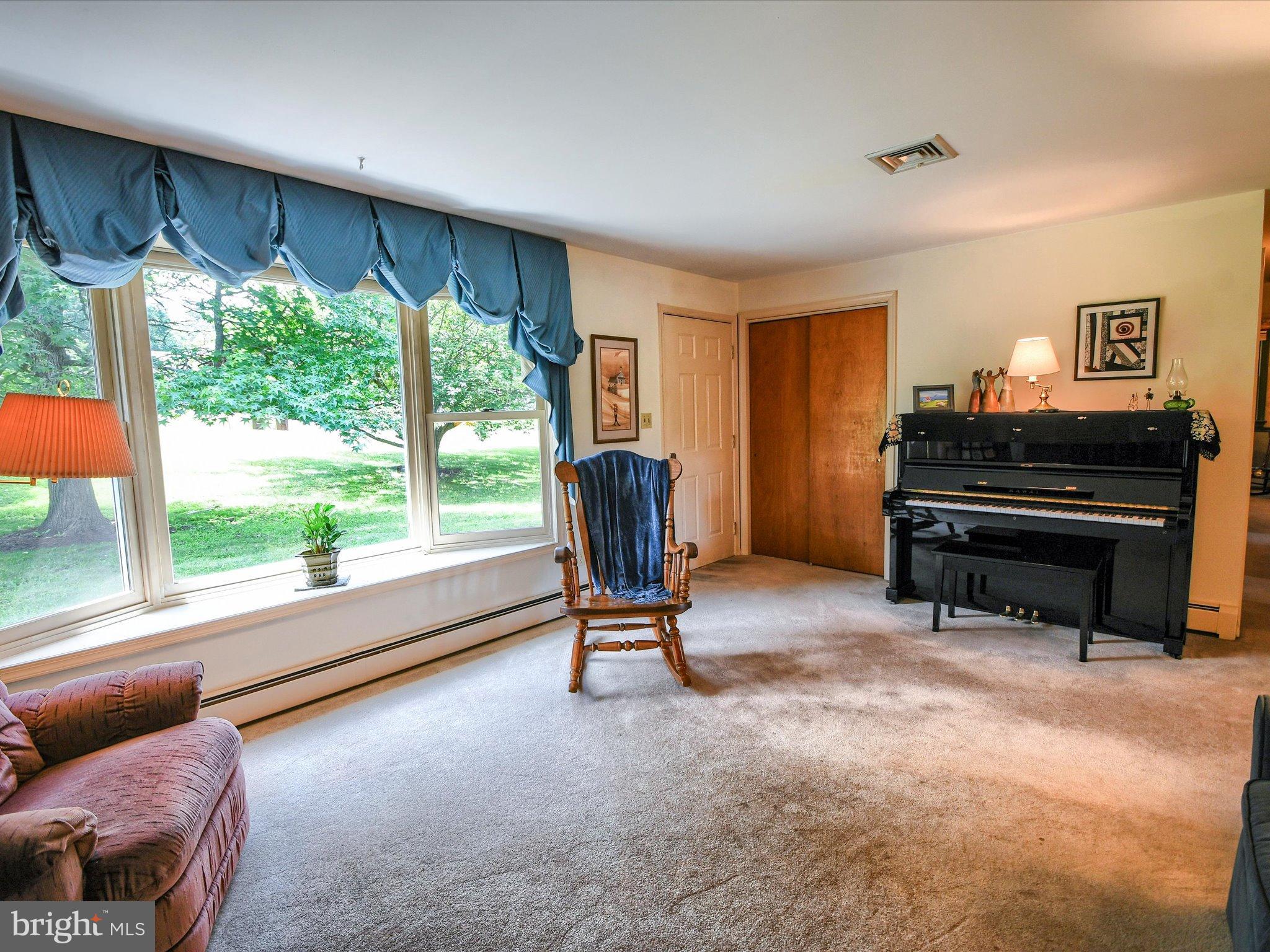 1209 Telegraph Road Perkasie, PA 18944 - Photo 12 of 49 a living room with furniture and a floor to ceiling window