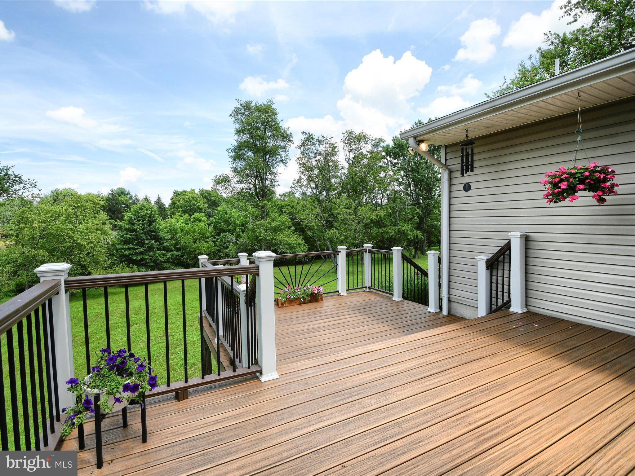 1209 Telegraph Road Perkasie, PA 18944 - Photo 15 of 49 a view of a chairs and table on the wooden deck