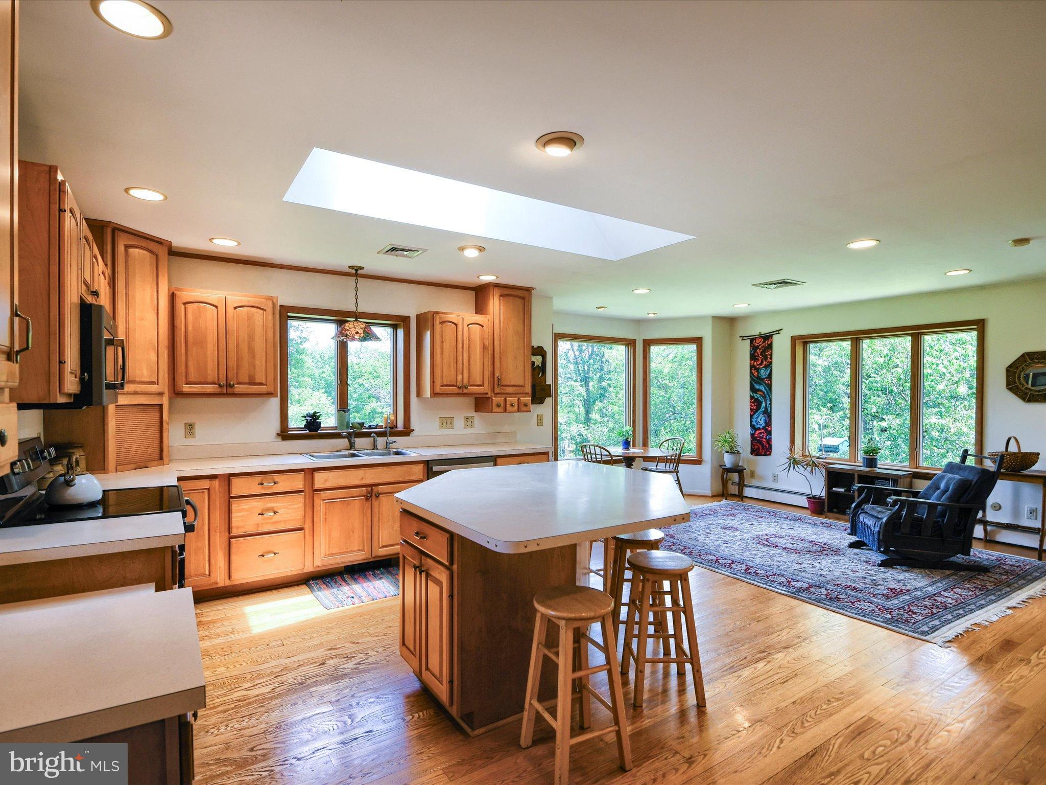 1209 Telegraph Road Perkasie, PA 18944 - Photo 2 of 49 a large kitchen with granite countertop a stove a sink a dining table and chairs