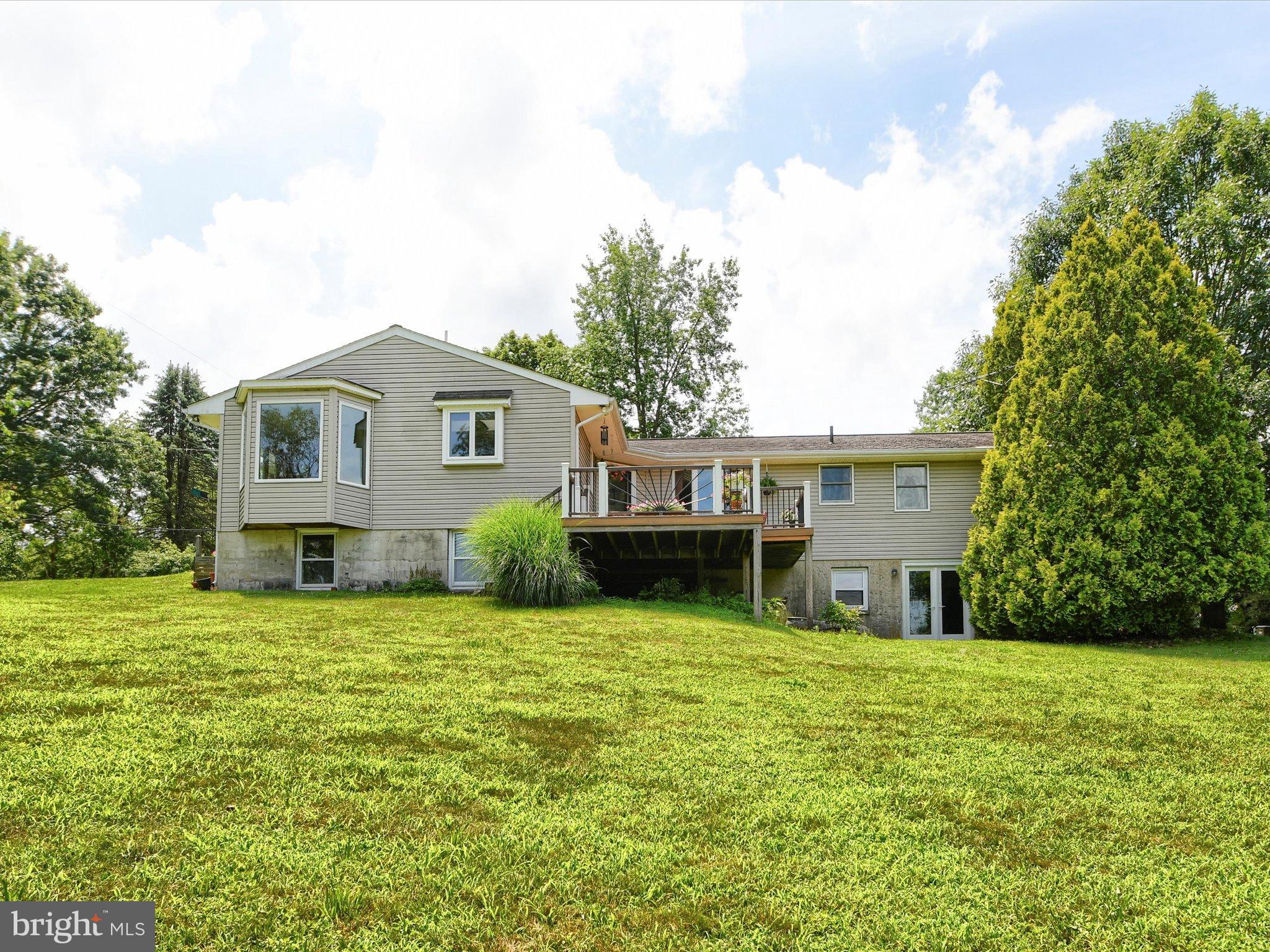 1209 Telegraph Road Perkasie, PA 18944 - Photo 46 of 49 a house that is sitting in the grass with tress in the background