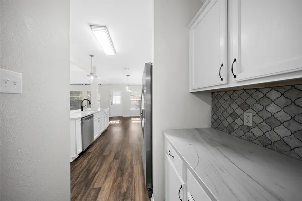 a bathroom with a sink a toilet a mirror and shower