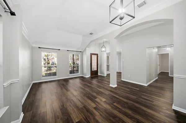 a view of empty room with wooden floor and fireplace
