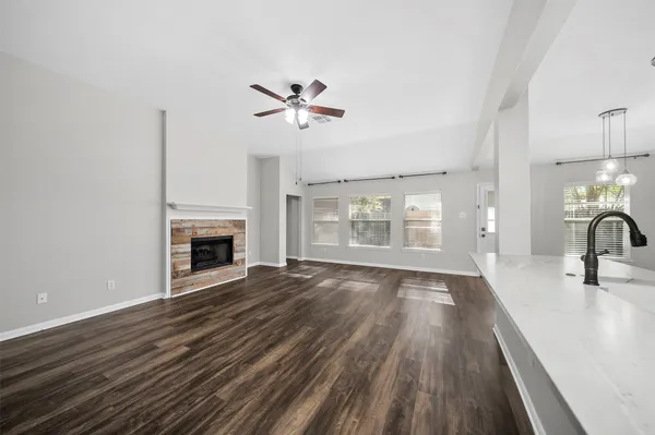 a large kitchen with stainless steel appliances kitchen island granite countertop a lot of counter space and wooden floor