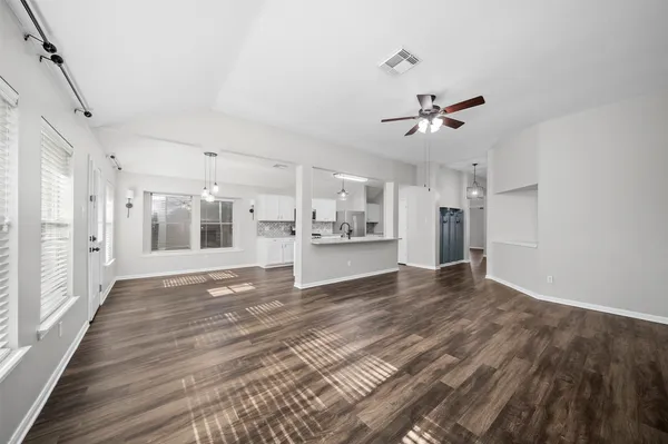 a view of a room with wooden floor and a window