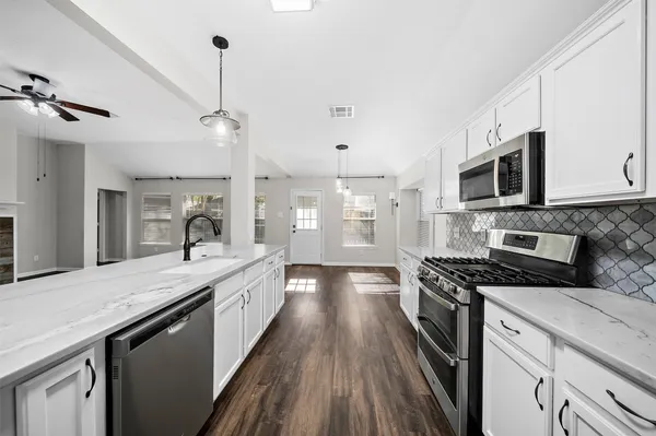 a bathroom with a double vanity sink a mirror and a shower