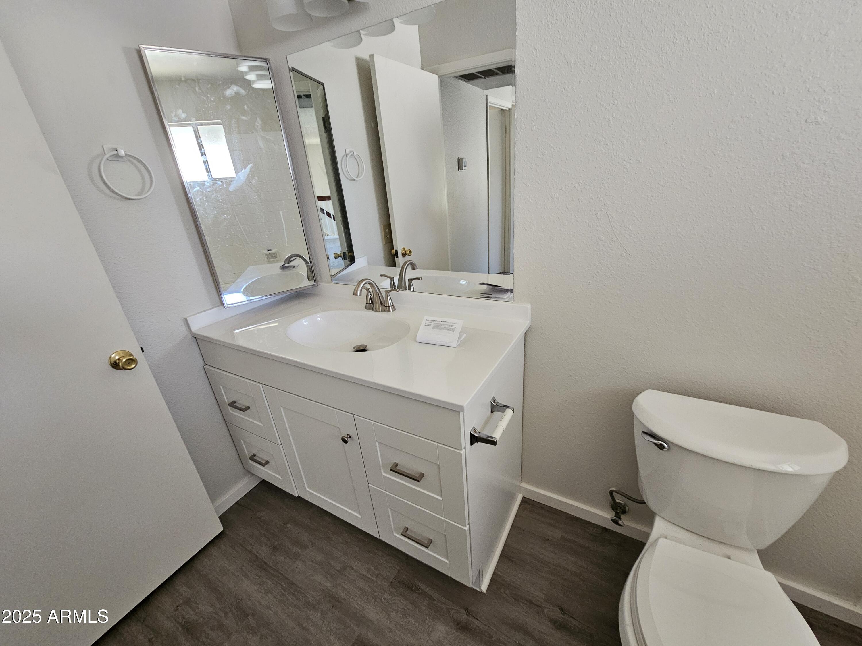 18227 North 45th Avenue Glendale, AZ 85308 - Photo 10 of 11 a bathroom with a toilet sink and mirror