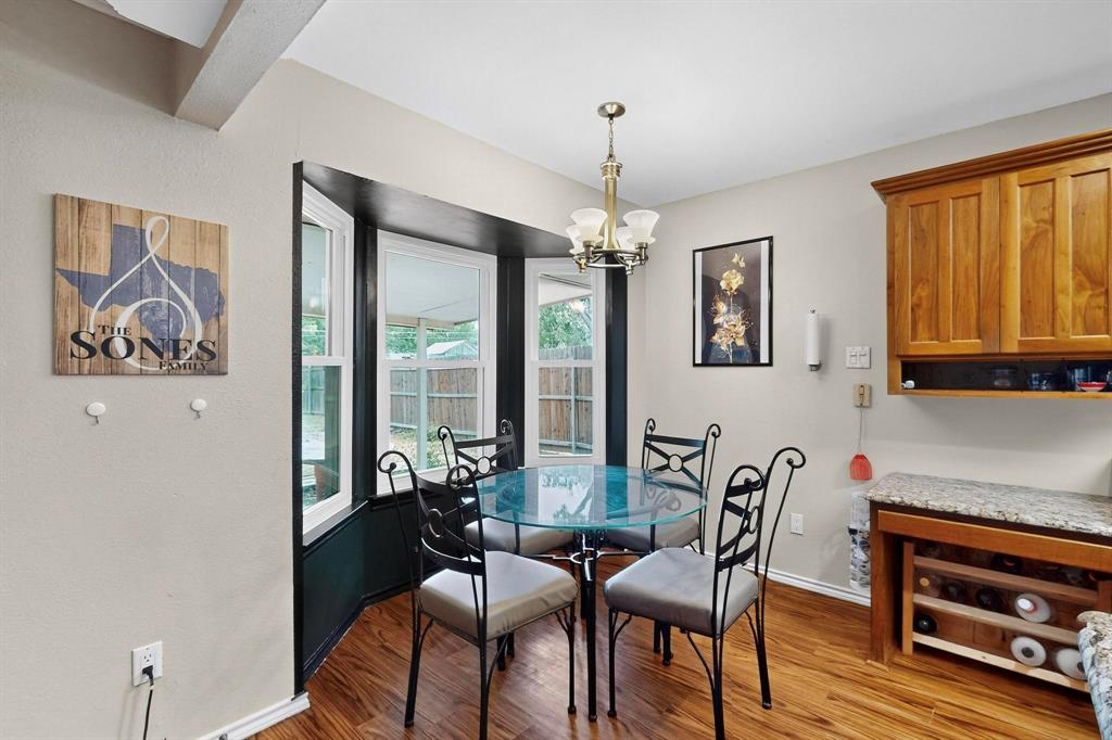 6617 Whitley Road Watauga, TX 76148 - Photo 15 of 36 a view of a dining room with furniture wooden floor and a chandelier