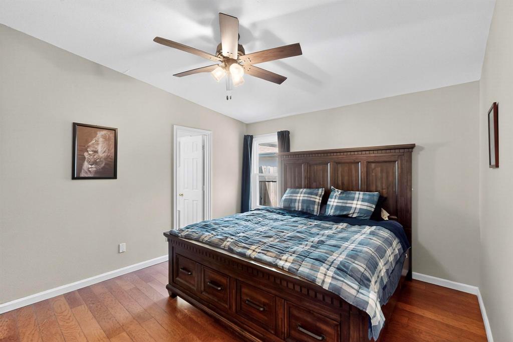 6617 Whitley Road Watauga, TX 76148 - Photo 17 of 36 a bedroom with a bed and a chandelier