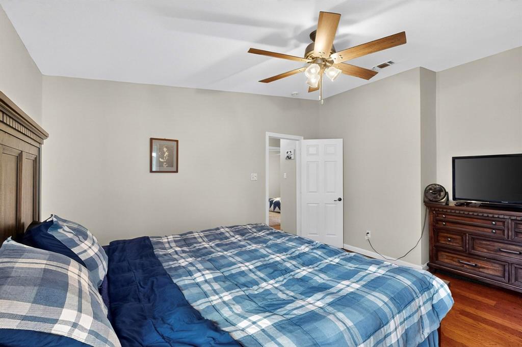 6617 Whitley Road Watauga, TX 76148 - Photo 19 of 36 a bedroom with a bed and a flat screen tv