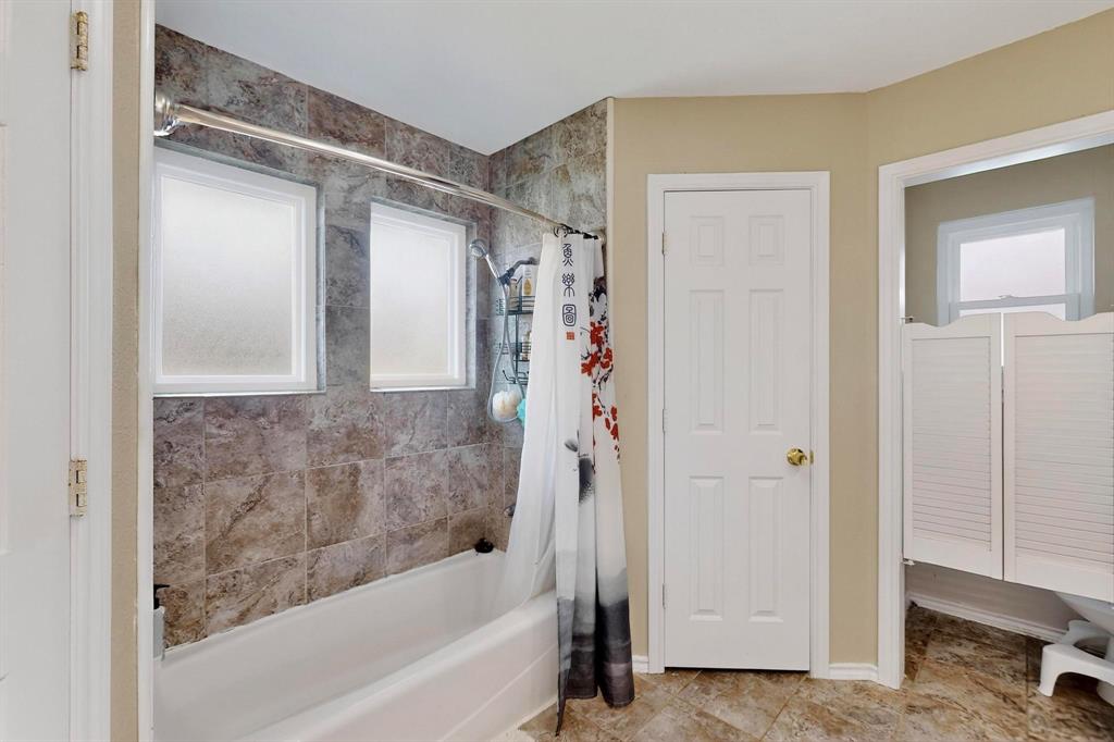 6617 Whitley Road Watauga, TX 76148 - Photo 22 of 36 a bathroom with a bathtub and a shower