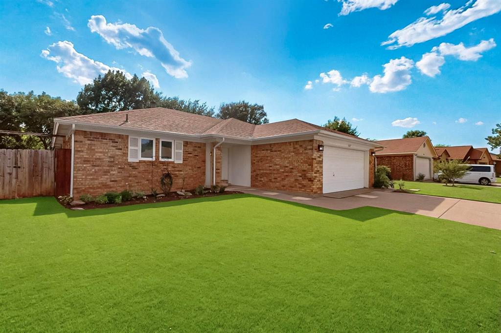 6617 Whitley Road Watauga, TX 76148 - Photo 3 of 36 a front view of a house with a garden