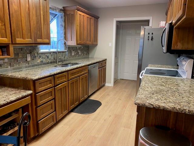 6617 Whitley Road Watauga, TX 76148 - Photo 7 of 36 a kitchen with stainless steel appliances granite countertop a sink stove and cabinets
