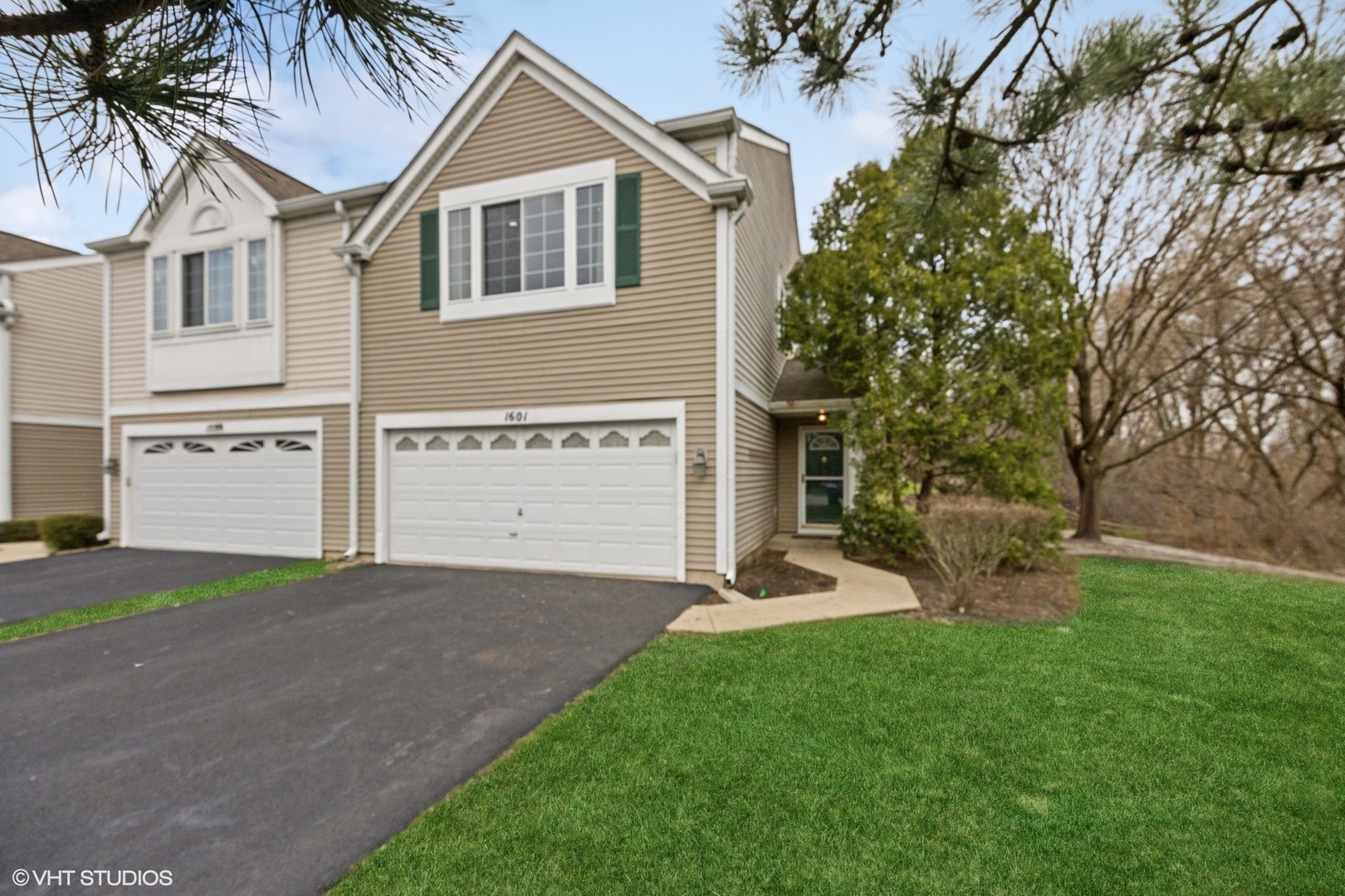 a front view of a house with a yard and garage