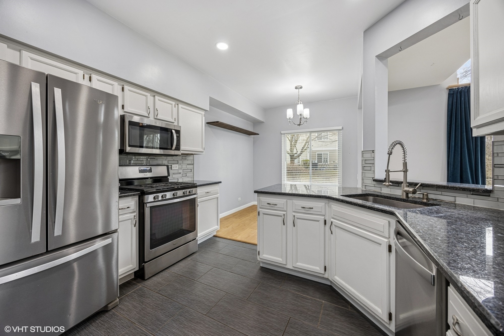 1601 Spaulding Road Bartlett, IL 60103 - Photo 6 of 15 a large kitchen with granite countertop a sink stainless steel appliances and cabinets