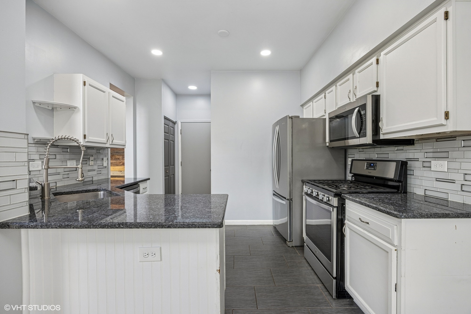 1601 Spaulding Road Bartlett, IL 60103 - Photo 7 of 15 a kitchen with stainless steel appliances granite countertop a stove a sink a refrigerator a microwave and cabinets